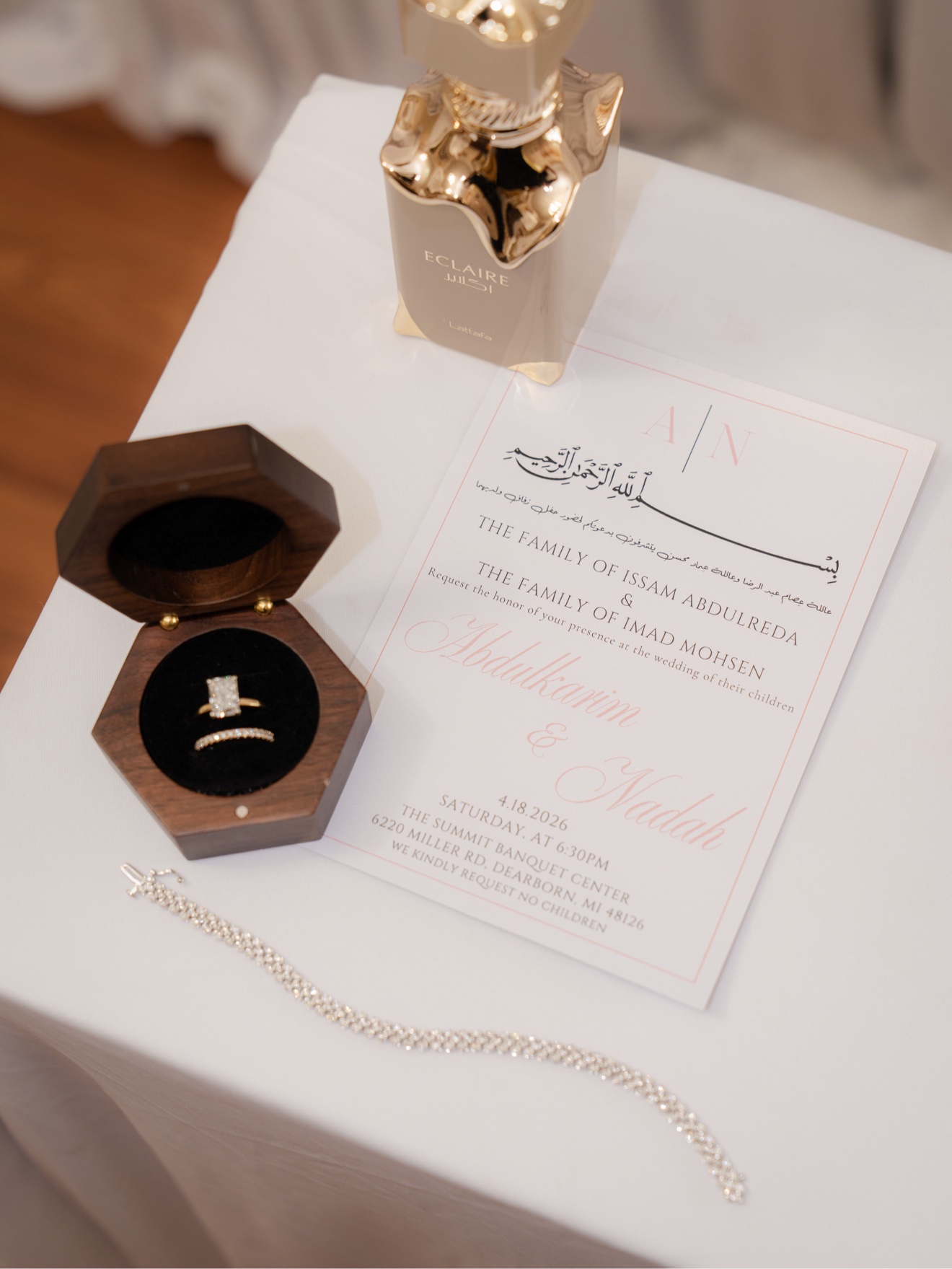 Abdul and Nadah wedding invitation, rings, fragrance, and jewelry