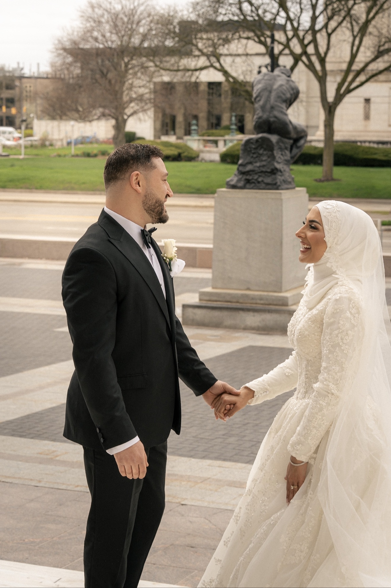 Abdul and Nadah smiling and holding hands on their wedding day