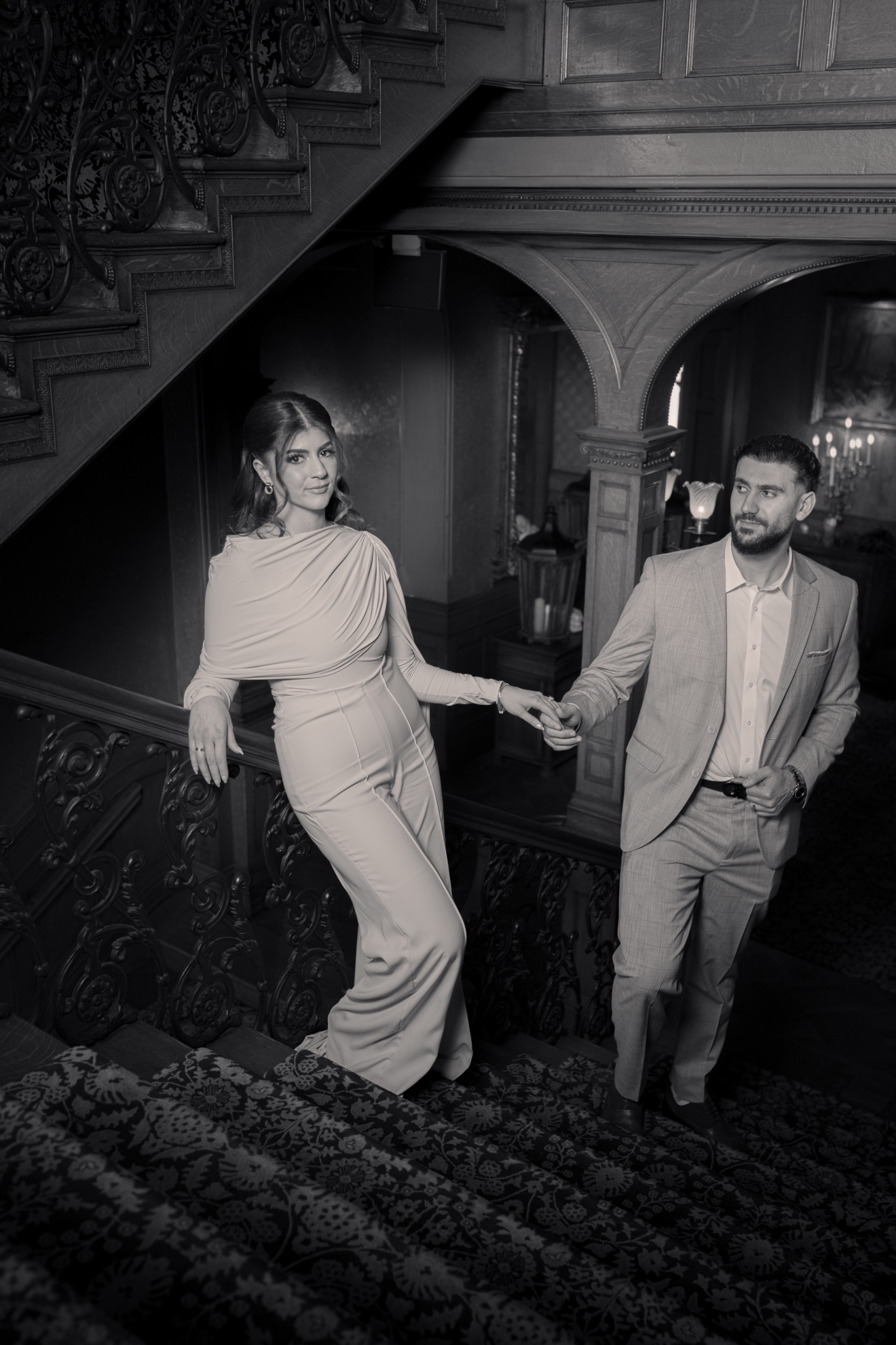 Black-and-white portrait of Hussein and Selena on an ornate staircase