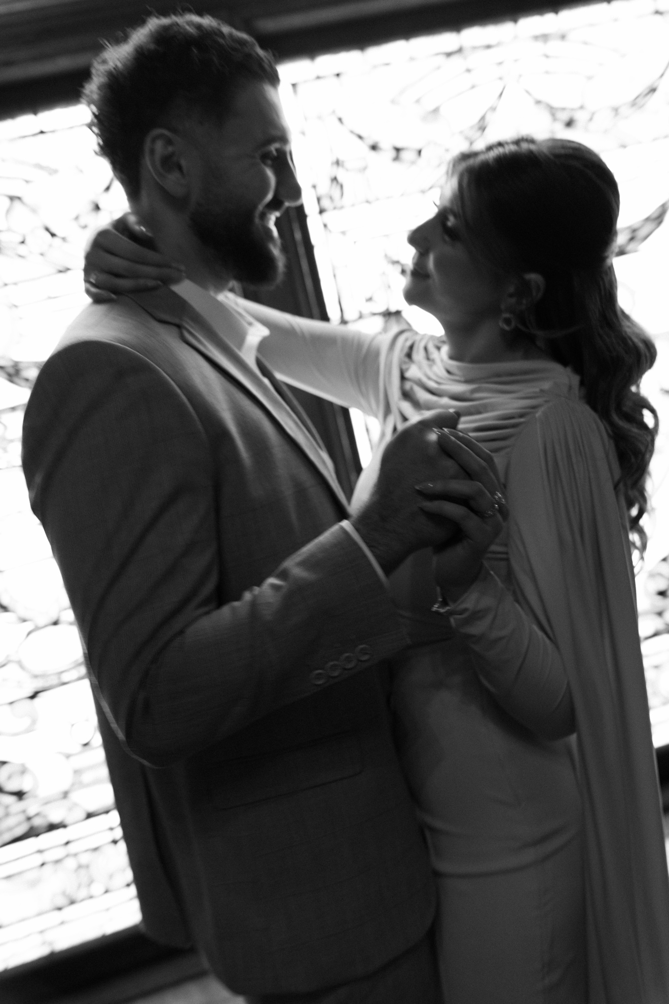 Black-and-white close portrait of Hussein and Selena dancing